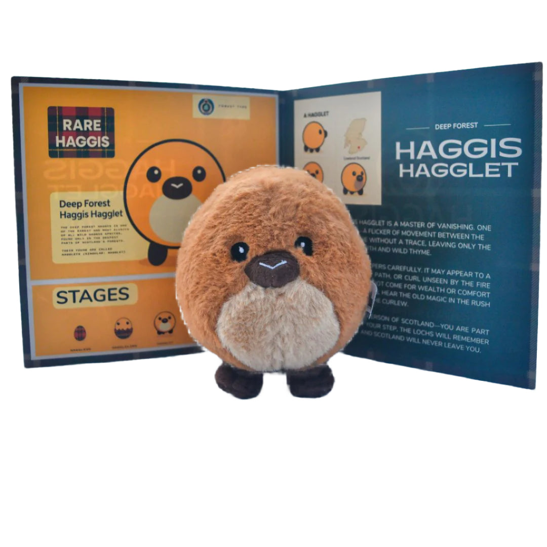 A 5-inch plush toy resembling a brown and beige wild haggis animal with a tuft of hair on its head, displayed in front of its packaging which includes an information card and a Haggis Wildlife Foundation Badge.