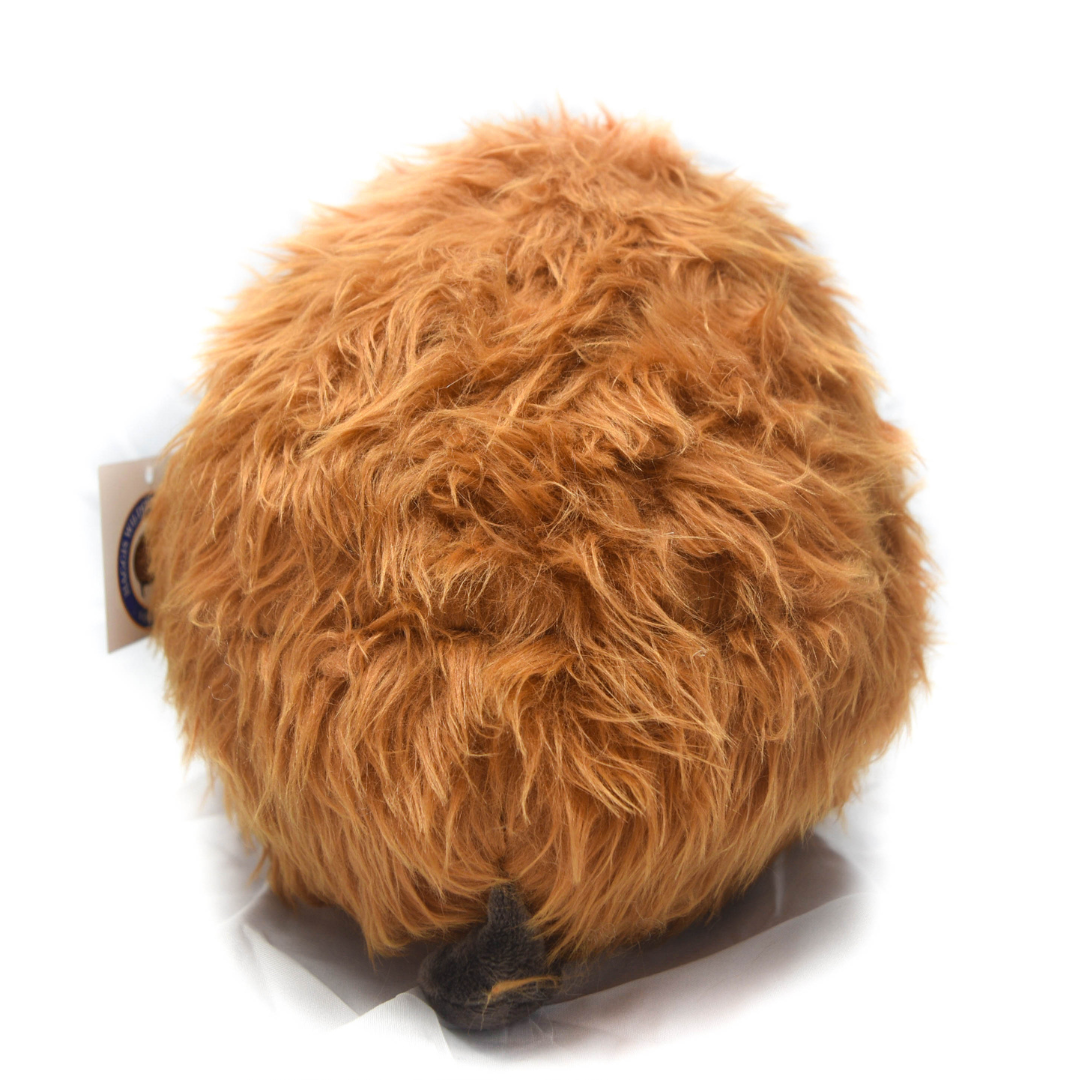 Brown fuzzy haggis with a tag on a white background